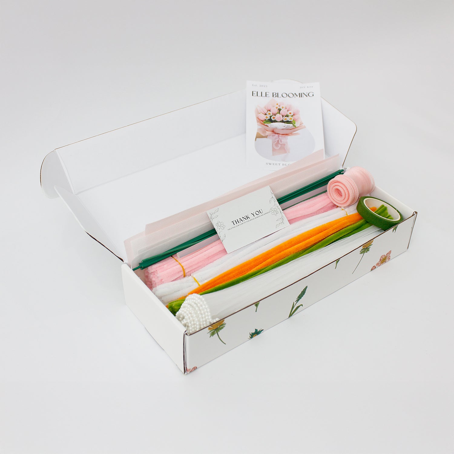 Sweet Blossoms DIY bouquet featuring soft pink tulips and white daisies made from fuzzy pipe cleaners. Wrapped in blush pink paper with a delicate sheer ribbon, this charming floral craft kit is ideal for handmade gifts and relaxing creativity.