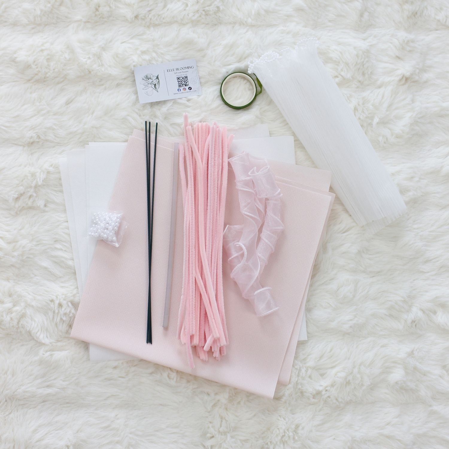 DIY bouquet of delicate pink hydrangea flowers, handmade from soft pipe cleaners with tiny pearl-like centers. Wrapped in soft pink and white paper with a sheer ribbon a dreamy handmade gift.