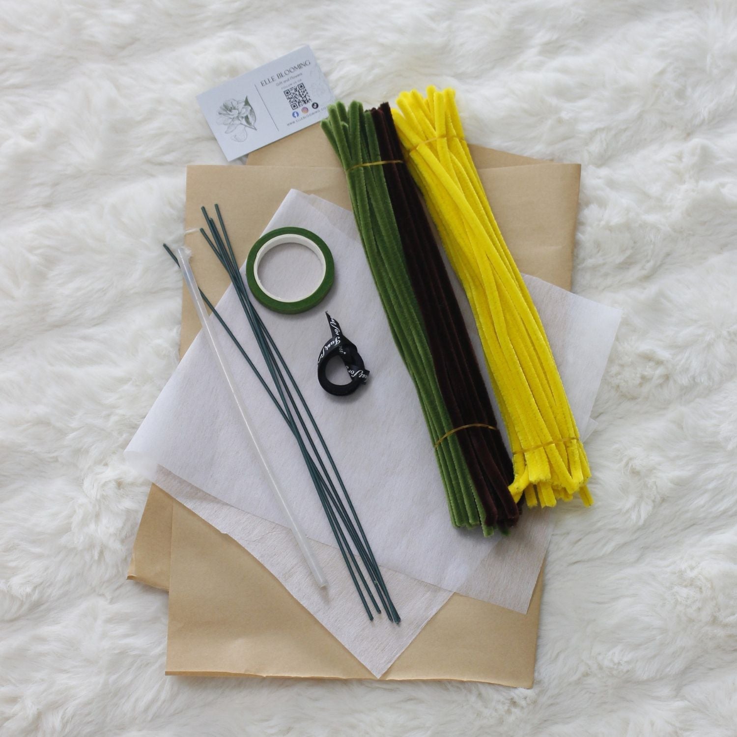 Yellow Sunflower DIY bouquet featuring two vibrant yellow pipe cleaner sunflowers with green leaves. Wrapped in kraft paper with black ribbon a handmade floral craft perfect for cheerful gifts and home décor.