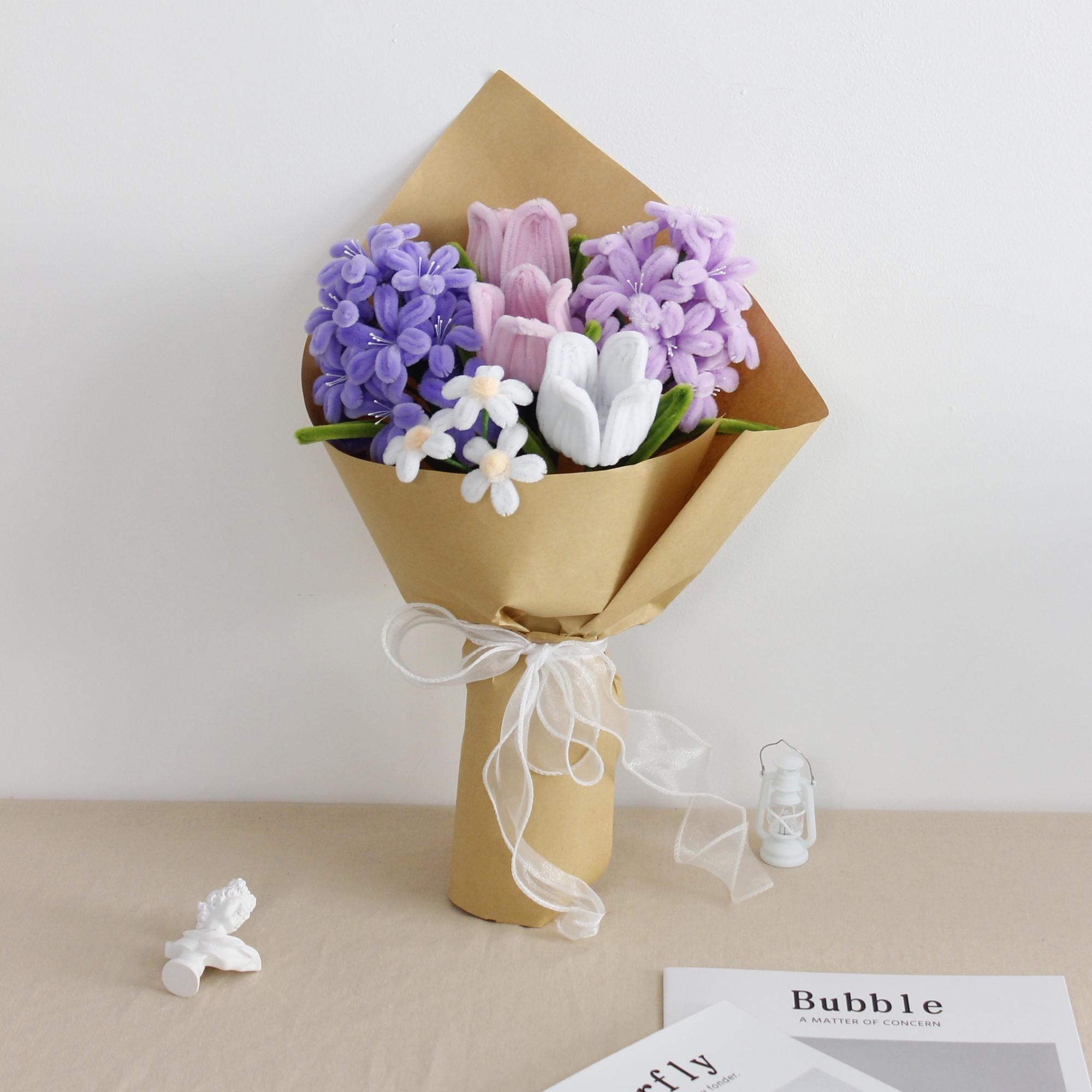 Violet Grace DIY bouquet featuring handcrafted lilac and purple hyacinths, pink and white tulips, and dainty white blossoms made from pipe cleaners. Wrapped in kraft paper with a soft white ribbon, perfect for elegant handmade gifts.