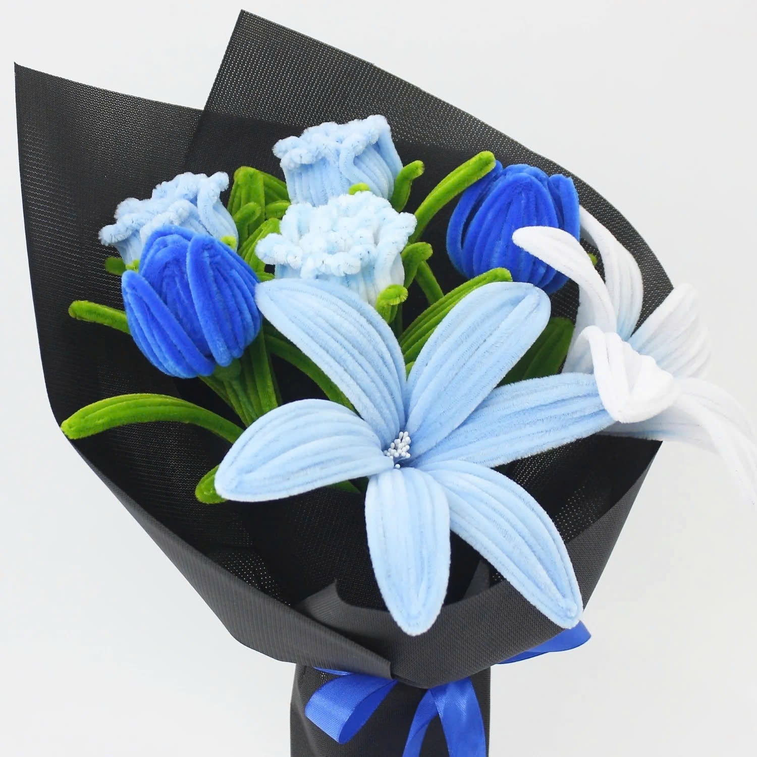 Bluence DIY bouquet with handmade blue, white, and light blue lilies crafted from pipe cleaners. Wrapped in sleek black paper with a royal blue ribbon, this elegant DIY floral kit is perfect for unique gifts and calming creative projects.
