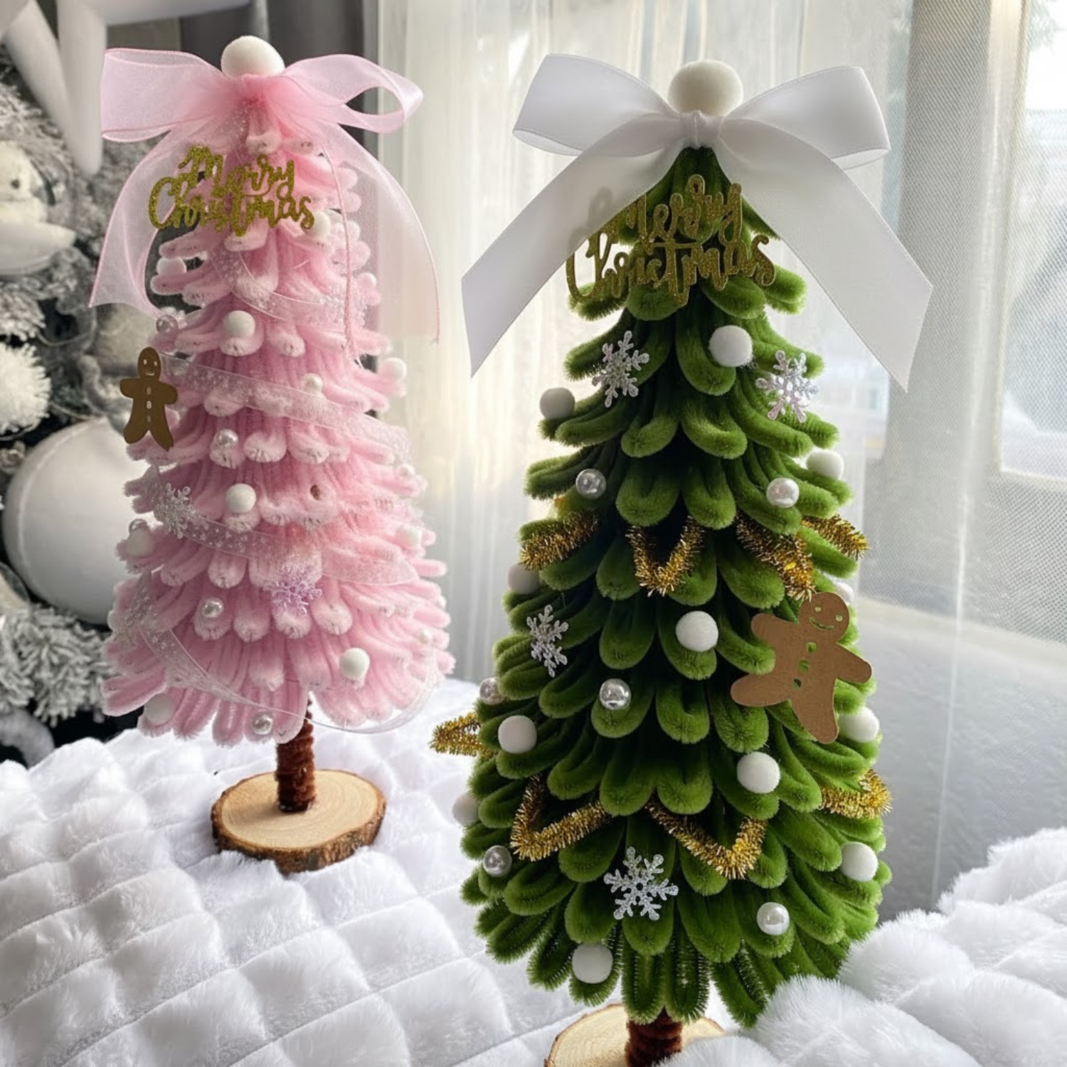 DIY Christmas tree set with one green and one pastel pink tree made from fuzzy pipe cleaners. Decorated with pearls, snowflakes, and gingerbread ornaments the perfect handmade holiday decor.