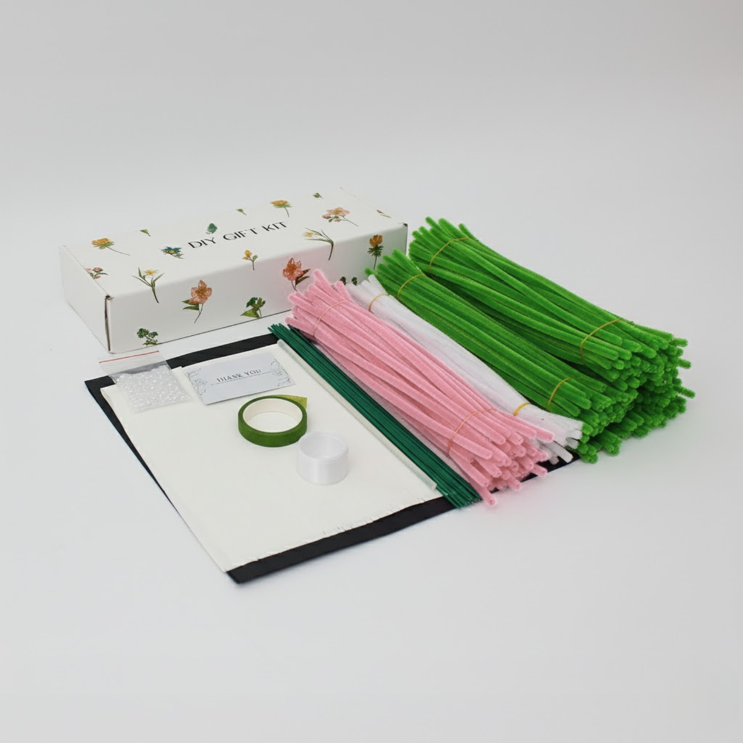 DIY Christmas tree set with one green and one pastel pink tree made from fuzzy pipe cleaners. Decorated with pearls, snowflakes, and gingerbread ornaments the perfect handmade holiday decor.