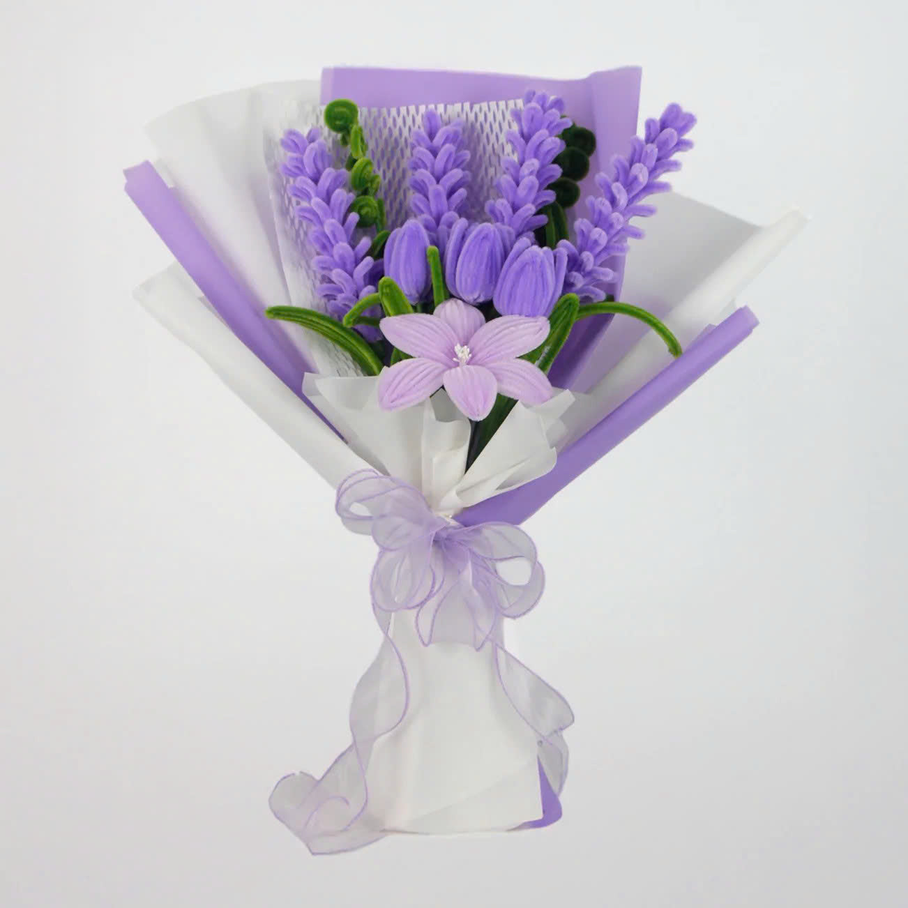 Enchanted Essence DIY flower bouquet featuring lavender stems, lilac tulips, and a central star lily made from soft pipe cleaners. Elegantly wrapped in lavender and white layers with a sheer ribbon bow a dreamy handmade gift idea.