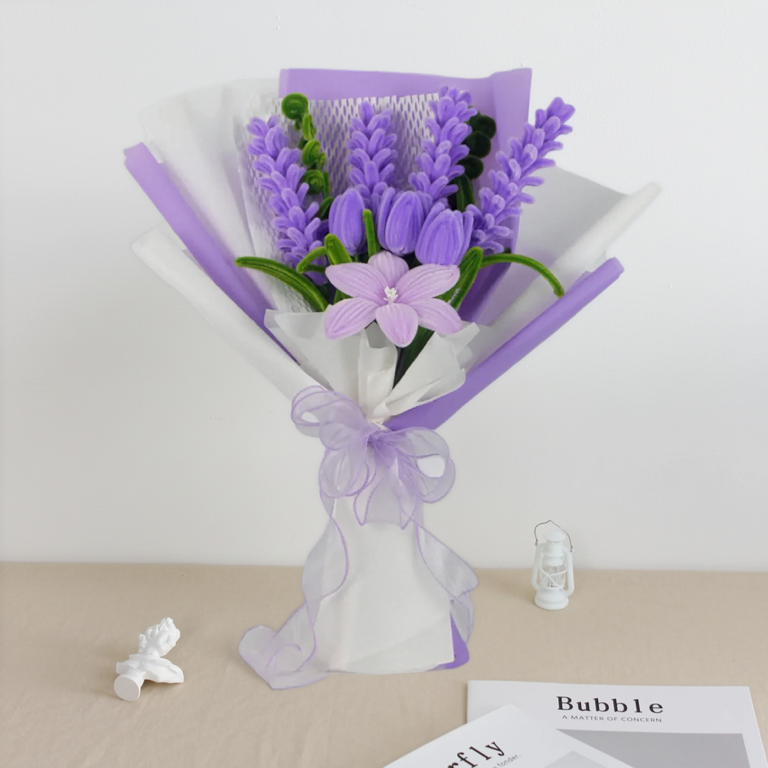 Purple lavender-inspired DIY bouquet made from pipe cleaners, featuring soft lilac flower spikes and delicate pastel blooms. Wrapped in layered purple and white packaging with a sheer ribbon, a calming handmade DIY flower kit perfect for gifting or home decor.