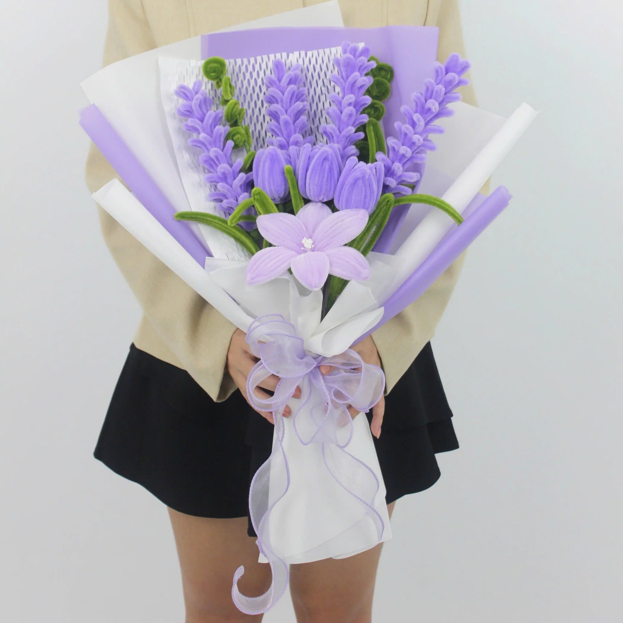 Enchanted Essence DIY flower bouquet featuring lavender stems, lilac tulips, and a central star lily made from soft pipe cleaners. Elegantly wrapped in lavender and white layers with a sheer ribbon bow a dreamy handmade gift idea.