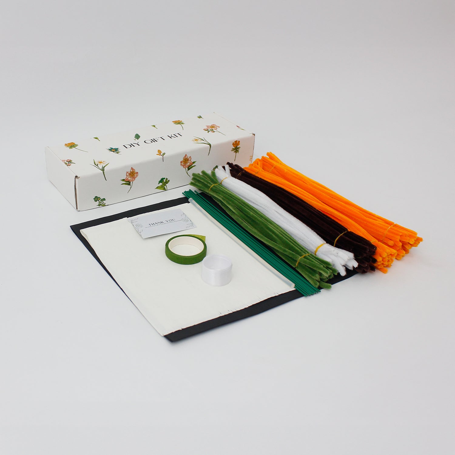 Golden Hour DIY sunflower bouquet made from vibrant orange pipe cleaners, featuring handmade daisies and lush green stems. Wrapped in black mesh and paper for a bold, elegant contrast ideal for DIY lovers and heartfelt handmade gifts.