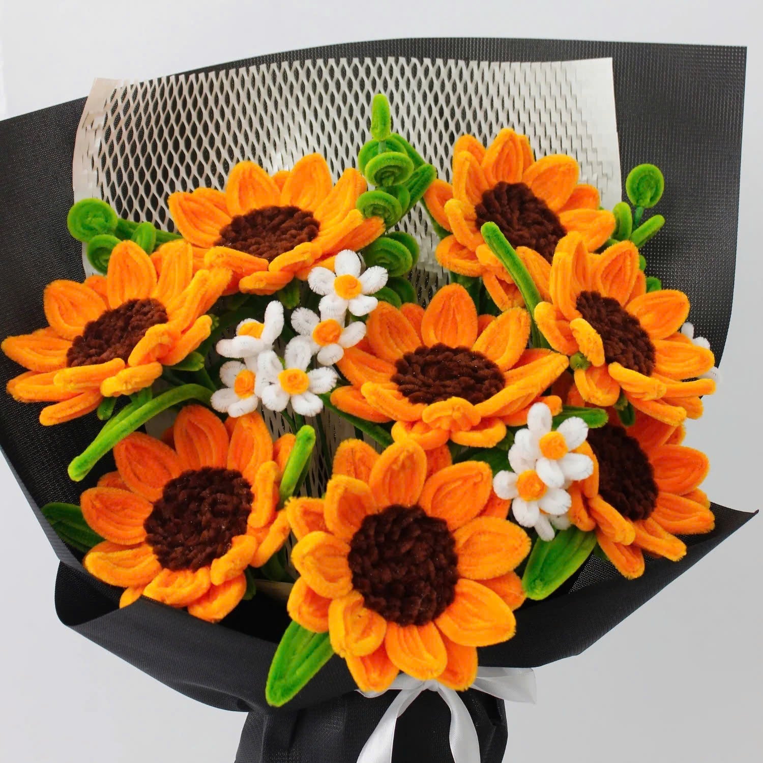 Golden Hour DIY sunflower bouquet made from vibrant orange pipe cleaners, featuring handmade daisies and lush green stems. Wrapped in black mesh and paper for a bold, elegant contrast ideal for DIY lovers and heartfelt handmade gifts.