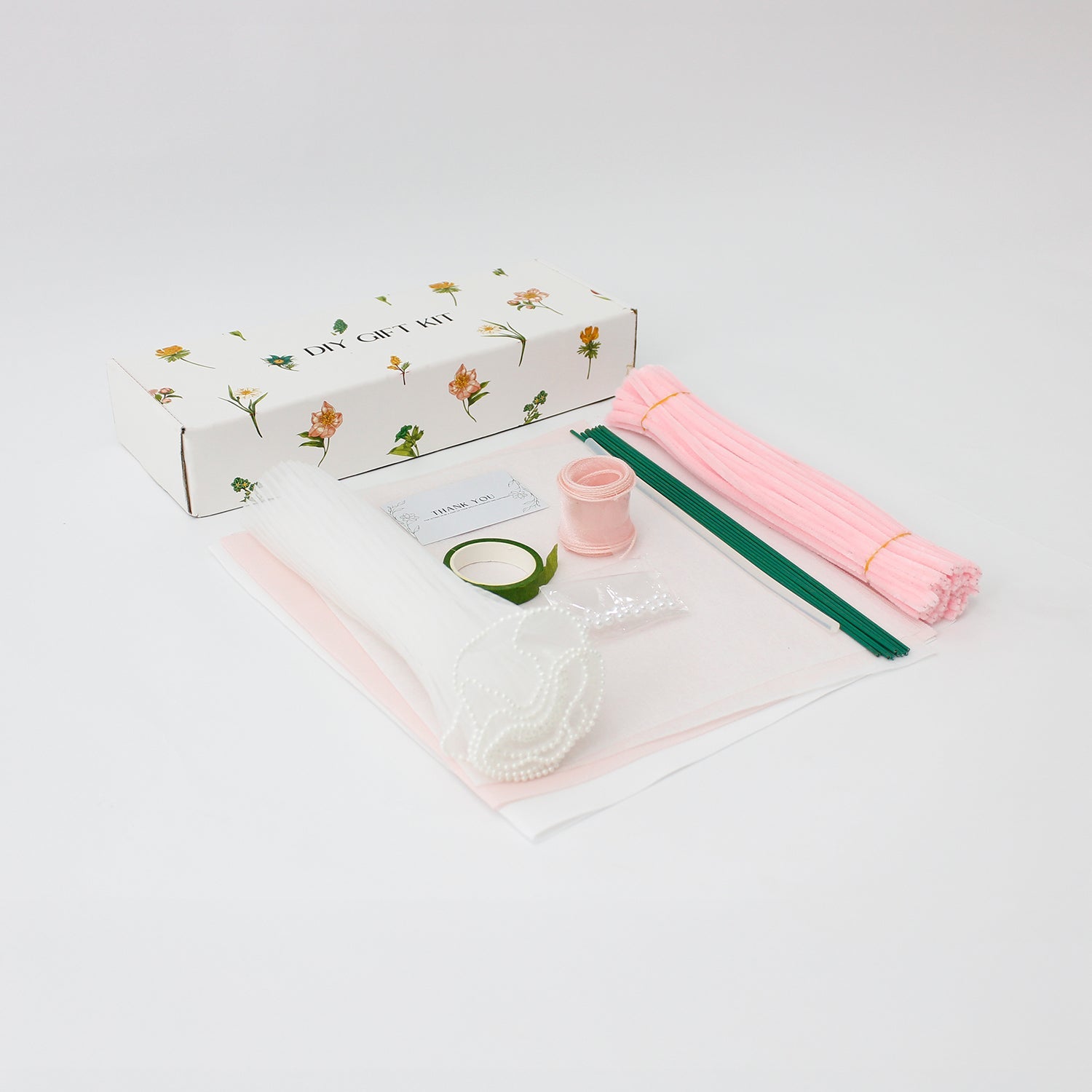 DIY bouquet of delicate pink hydrangea flowers, handmade from soft pipe cleaners with tiny pearl-like centers. Wrapped in soft pink and white paper with a sheer ribbon a dreamy handmade gift.