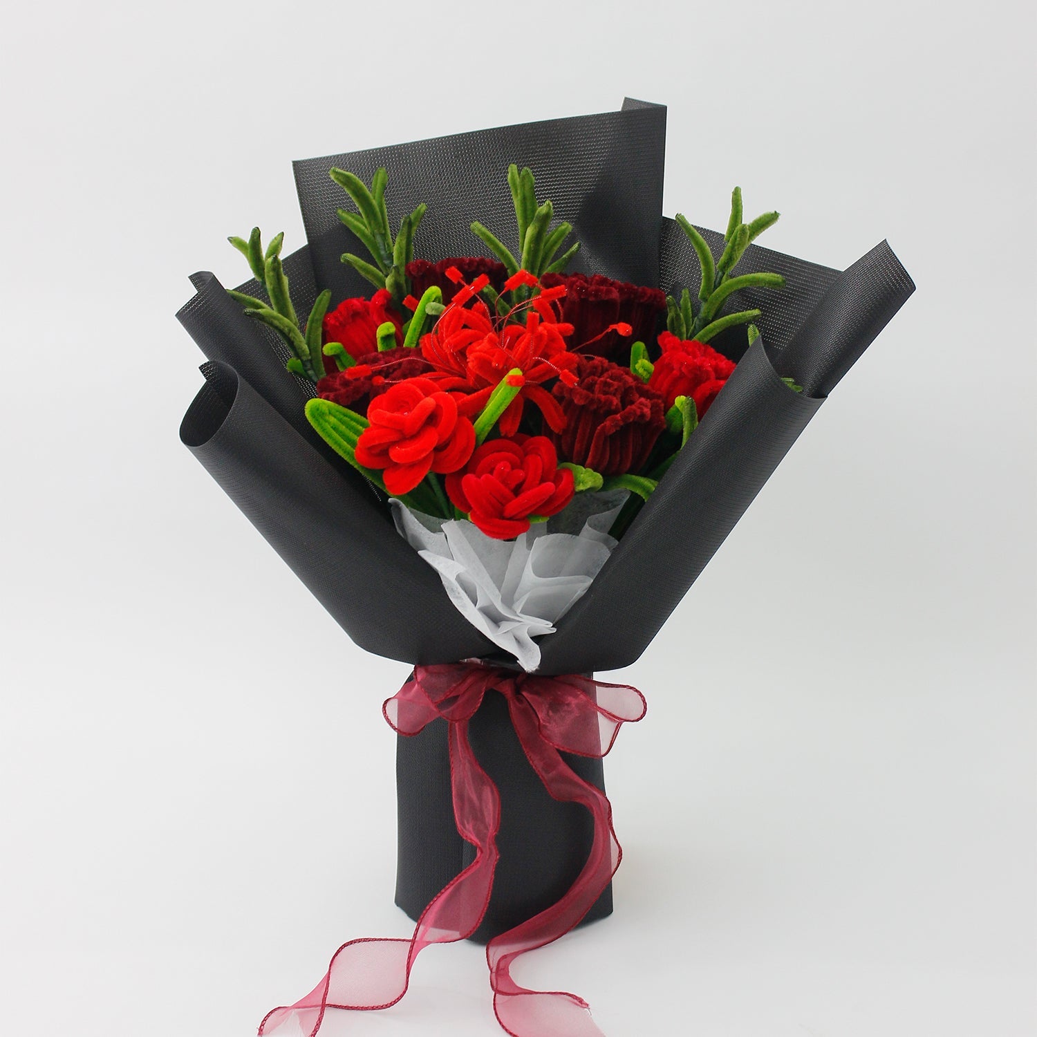 Bouquet of red roses flowers wrapped in black paper with a red ribbon on a white background