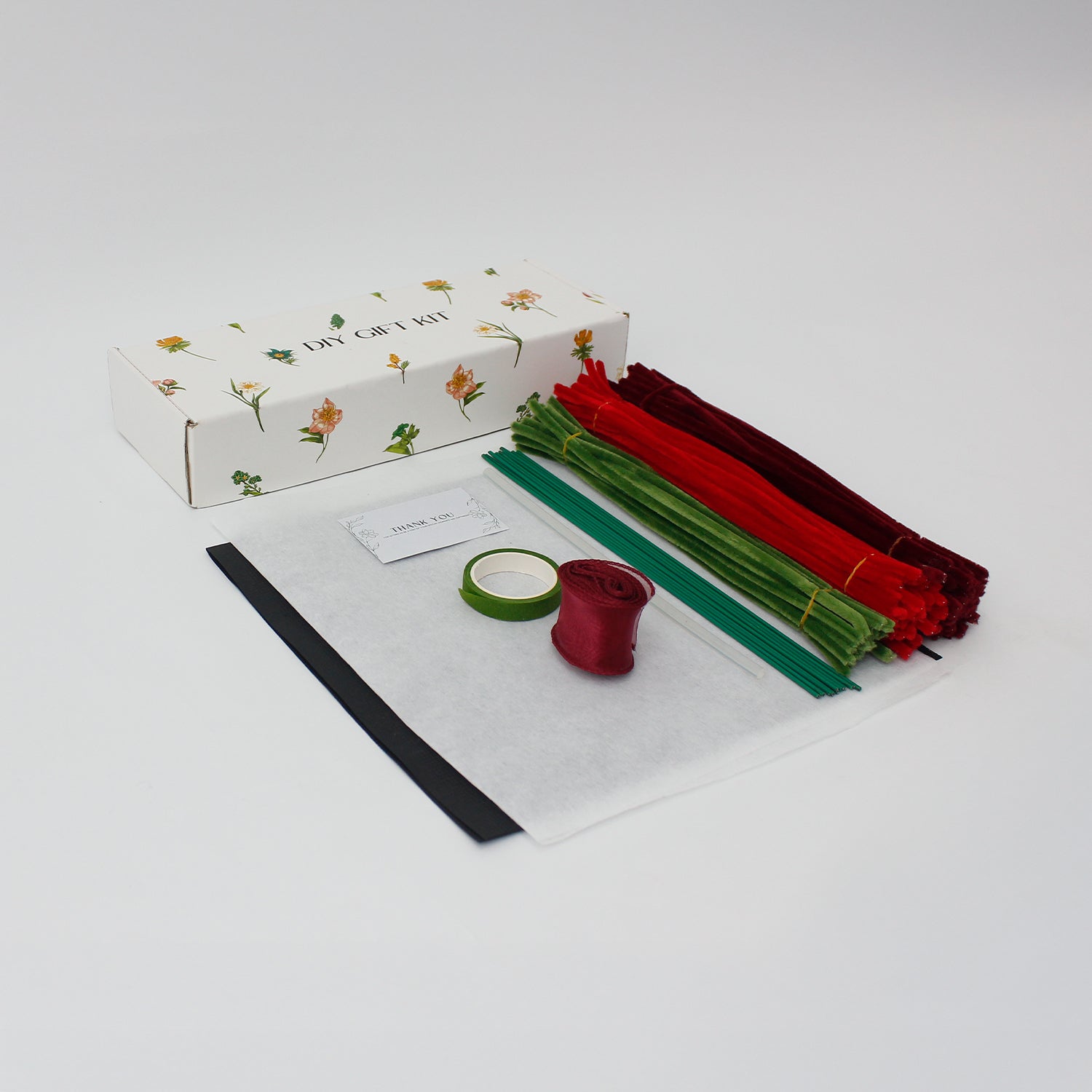 Bouquet of red roses flowers wrapped in black paper with a red ribbon on a white background