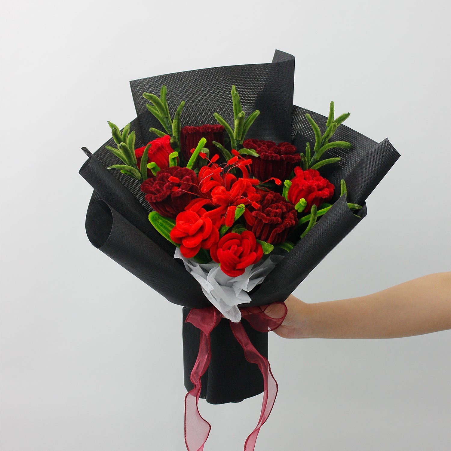 Rouge Noir DIY bouquet with deep red carnations, roses, and celosia handcrafted from pipe cleaners. Wrapped in elegant black paper and tied with a burgundy ribbon, this bold floral arrangement is perfect for romantic or dramatic handmade gifts.