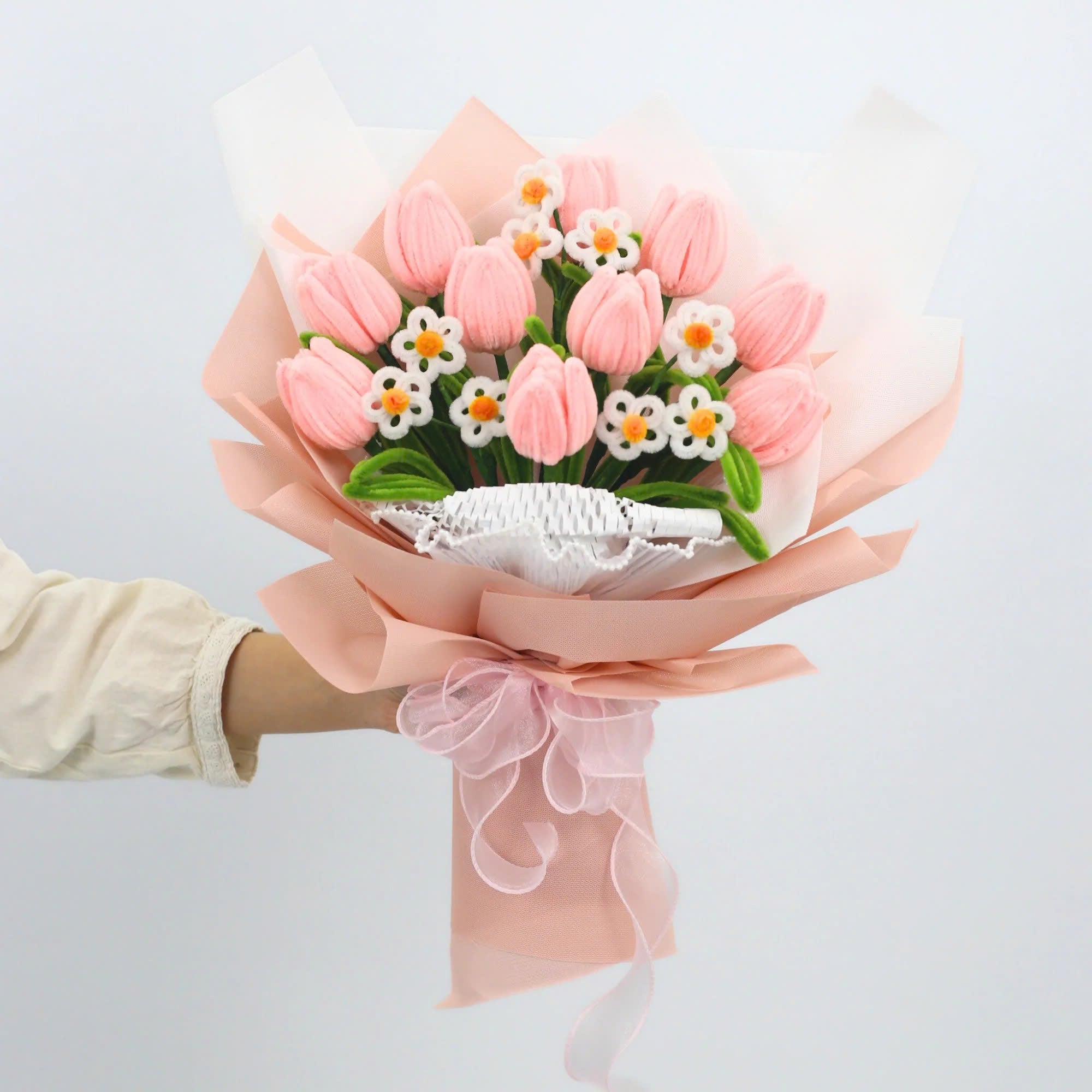 Sweet Blossoms DIY bouquet featuring soft pink tulips and white daisies made from fuzzy pipe cleaners. Wrapped in blush pink paper with a delicate sheer ribbon, this charming floral craft kit is ideal for handmade gifts and relaxing creativity.