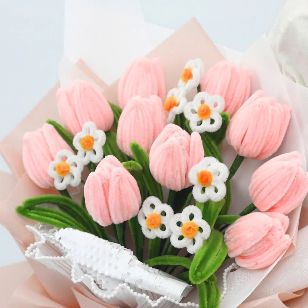 Sweet Blossoms DIY bouquet featuring soft pink tulips and white daisies made from fuzzy pipe cleaners. Wrapped in blush pink paper with a delicate sheer ribbon, this charming floral craft kit is ideal for handmade gifts and relaxing creativity.