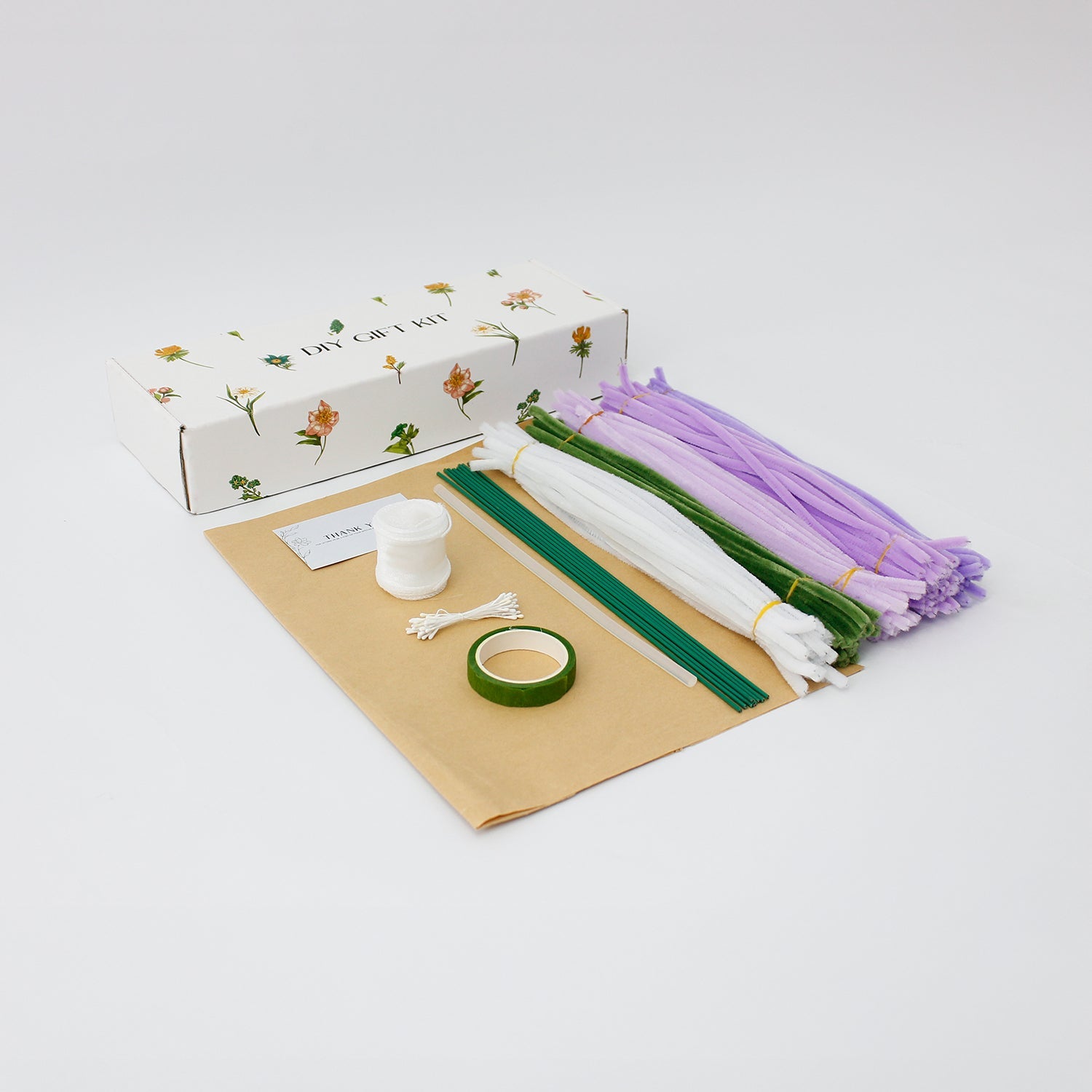 Violet Grace DIY bouquet featuring handcrafted lilac and purple hyacinths, pink and white tulips, and dainty white blossoms made from pipe cleaners. Wrapped in kraft paper with a soft white ribbon, perfect for elegant handmade gifts.