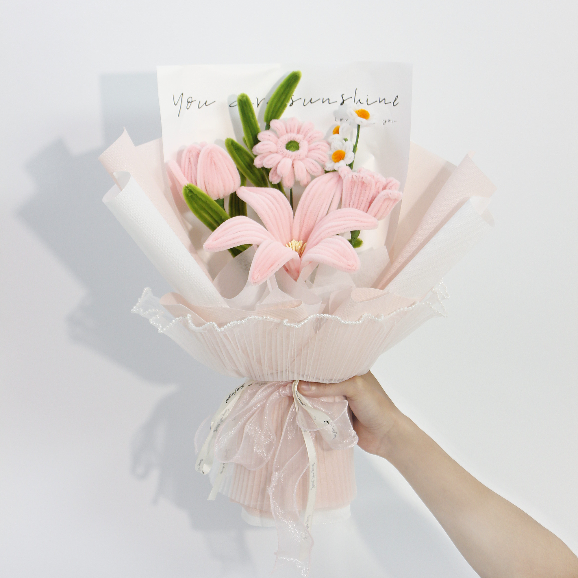 Elegant pink pipe cleaner DIY kit featuring lilies and daisies, includes full set of materials for crafting your own floral bouquet.
