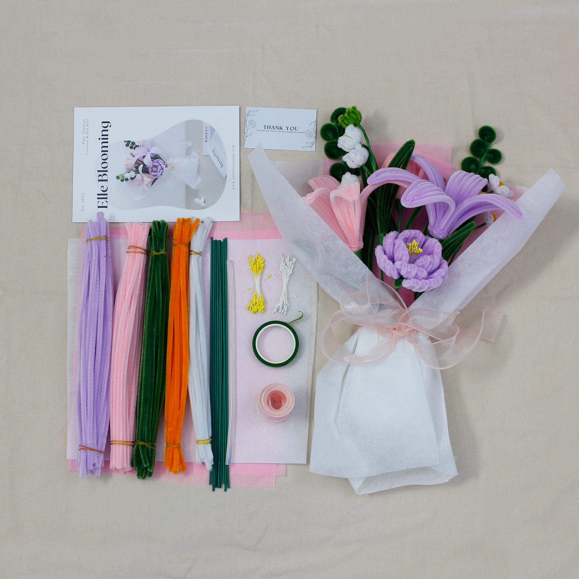Pastel pipe cleaner bouquet DIY kit with lilies and daisies, complete with wrapping paper and crafting tools — perfect for handmade gifts and relaxing flower craft time.
